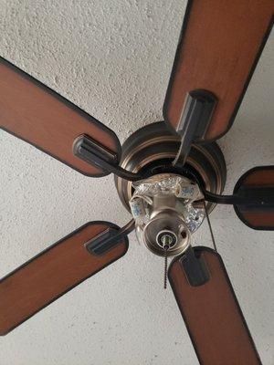 The crappy cieling fan with "taped on lightbulbs"