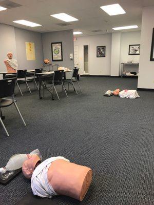 Classroom with several models to practice cpr on