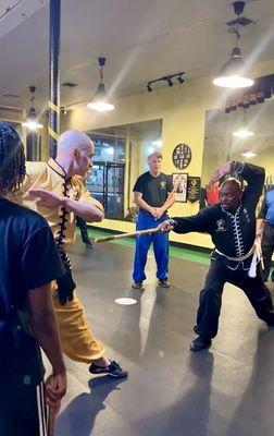 Sifu Kenneth and student demonstrating the short staff in the teen/adult evening class. Northern Shaolin Eagle Claw Kung Fu