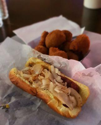 German dog with sauerkraut, grilled onions, and mustard on a split and grilled dog and toasted bun. Mmmm!