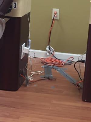 The weird electrical connection across from my broken massage chair. Duct tape and dust.