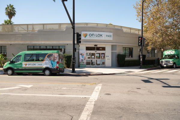 On Lok PACE San Jose Center. This photo is of the entrance to the building, featuring two our vans.