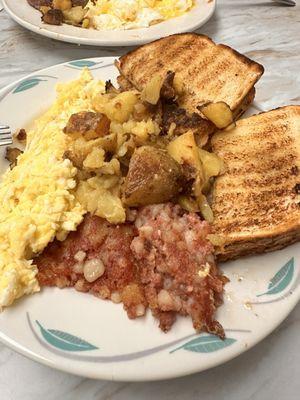 Scrambled eggs, hash browns, corned beef hash & sourdough toast. Great tasting breakfast & very filling.