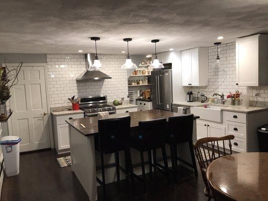 Subway tile backsplash counter to ceiling above oven.