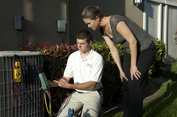 Joshua Gleason helping a customer understand the refrigeration process.