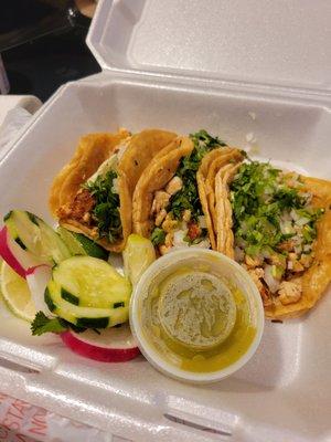 Street tacos!!! With radish, cucumbers, green salsa, lime and cilantro on corn tortillas.