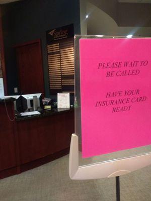 The welcoming sign before the reception robot squad expressionlessly checks you in.