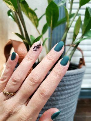 Matte teal/pine green gel nails with a foliage design