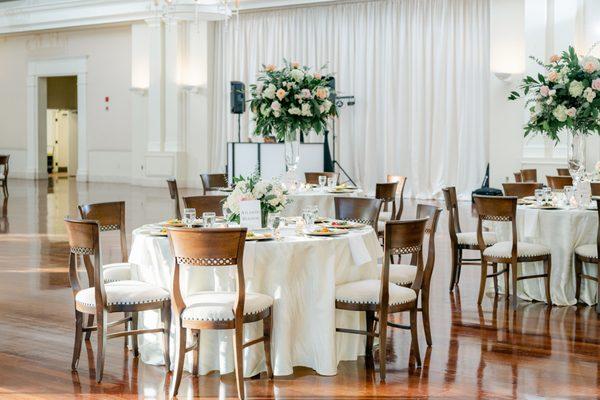 Estate table flowers and candles and reception table centerpieces by UFE. Photo by Leigh Wolfe Photography. Venue: Atlanta History Center.