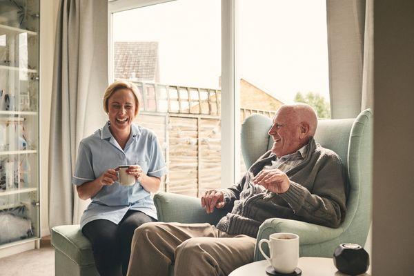 "Sharing a Moment: Caregiver and Senior Enjoy a Relaxing Tea Time Together"