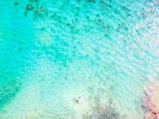 Drone photo of a couple floating in the ocean