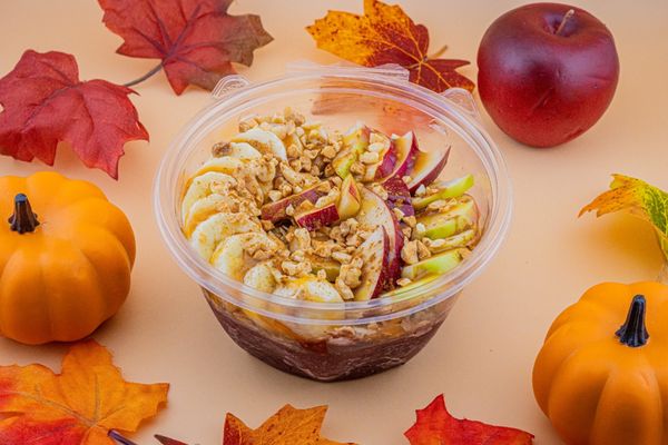 Apple-licious Smoothie bowl. Açaí base topped with apples, banana, caramel drizzle, peanuts and cinnamon.