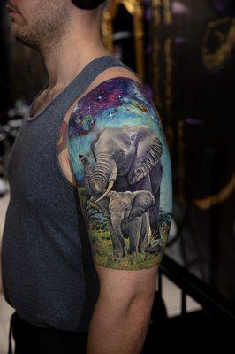 Realistic elephants galaxy tattoo by Mikhail`