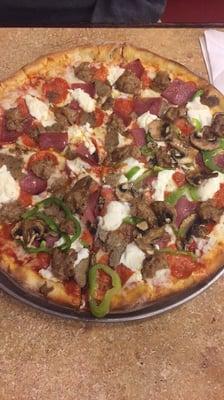 Meat lovers large pizza with ricotta cheese, mushrooms, and green peppers added. Really really good!