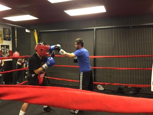 Coach Will sparring with Mark one of our young boxers