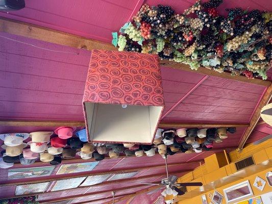 Unique ceiling view! Full of hats tacked on ceiling!