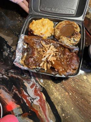 Smothered pork steak, macaroni and cheese and dressing