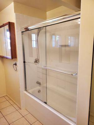 1/4" clear glass frameless bypass sliding doors on tub.