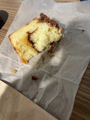 Cinnamon cake with a cinnamon sugar swirl in the center and a crumb topping.