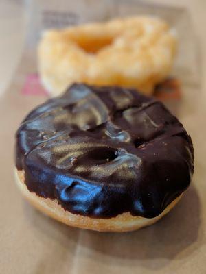 Close-up of Boston Kreme donut ($1.09). In background: French cruller ($1.09).