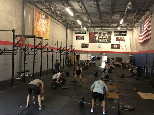 Morning power clean instruction. A great thing about CrossFit is you have a coach to train you and buddies to cheer you on