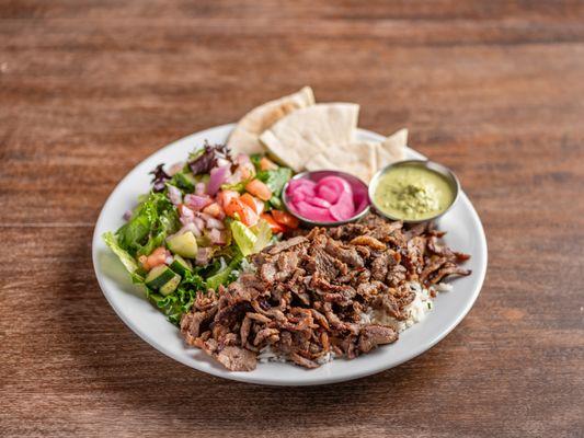 Döner Plate with basmati rice, house salad, pita bread slices, your choice of in-house made sauce, and pickled red onions.