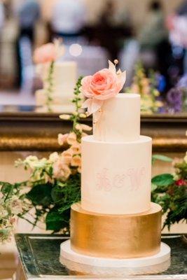 Rose gold sugar flower on top of fondant; inside was lemon-poppyseed cake with blackberry fruit preserves