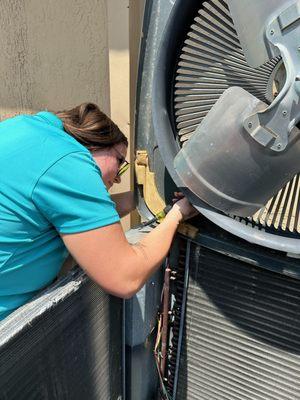 Repairing a loose baffle on the AC fan cover.