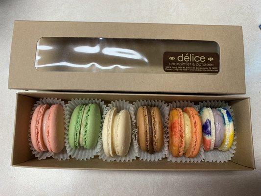 Half dozen variety pack of macarons: strawberry, pistachio, vanilla, chocolate, pumpkin spice and unicorn (left to right).