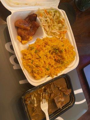 Curry Goat, yellow rice , plantains, and cabbage