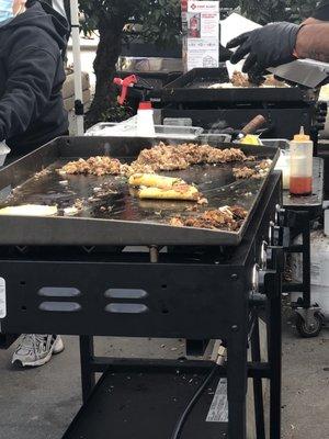 Birria tacos being cooked.