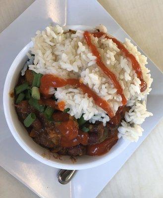 Vegan red bean chili with steamed rice and hot sauce