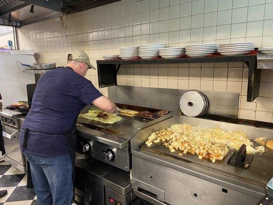 This is the short order cook and wow, is he amazing! Look at him preparing that omelette!!