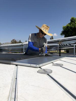 Jaime Mejia re-screening a swinging screen door on our mobile screen table. Burbank, CA