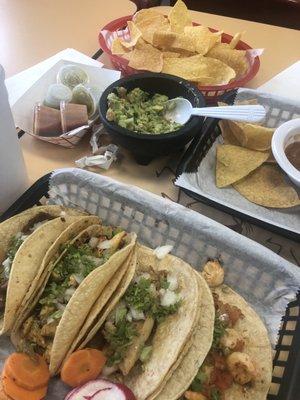 Fish taco, chicken taco, shrimp taco, el pastor (pork) taco and chips, salsa and guacamole