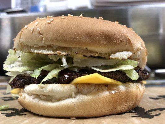 Lot-O-Burger with a toasted sesame seed bun, American cheese, dressed; mayo, mustard, onions (mixed together) pickle, lettuce & tomato.