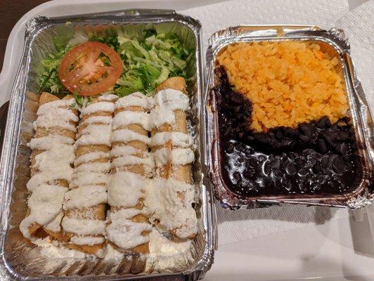 Chicken flautas with shredded lettuce, rice and beans