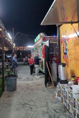 Folks ordering at a food truck with many options around.