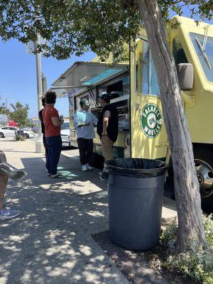 Dudes ordering from Felafel on Wheels.