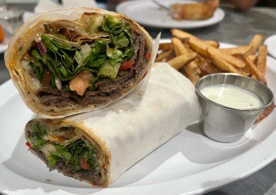 Zizi's Favorite Doner Wrap. Thin dough topped with seasoned ground beef and mozzarella cheese, Doner (A homemade Gyro)