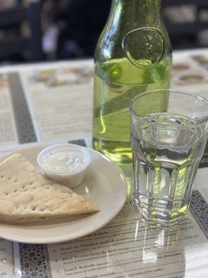 Warm water with complimentary bland tzatziki sauce and pita bread