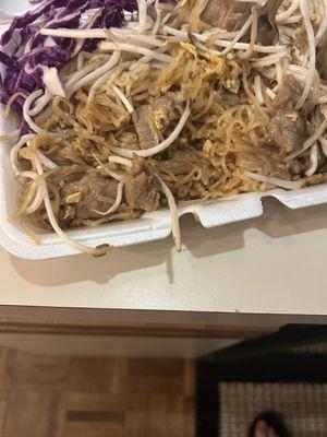 Raman noodles with a touch of beef and a bunch of bean sprouts and cabbage.