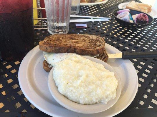 Fried egg sandwich on rye with grits