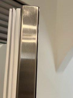 After market metal piece was affixed to door panel and edges are raw metal that is sharp as a blade.