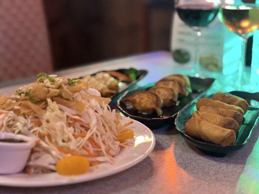 Foreground: Asian salad From right: egg rolls, potstickers, fried shrimp