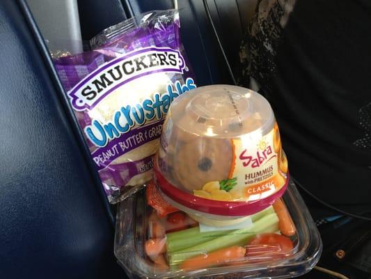 Hummus, pretzel chips, veggies and peanut butter.