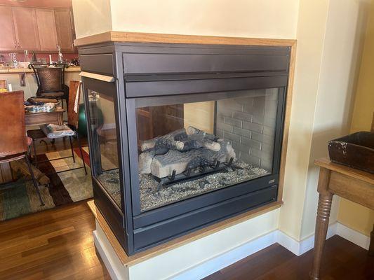 The 3-sided glass fireplace cleaned by QFS.