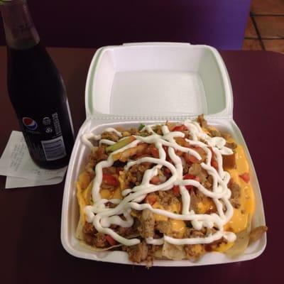 Chicken nachos with a bottle of Pepsi