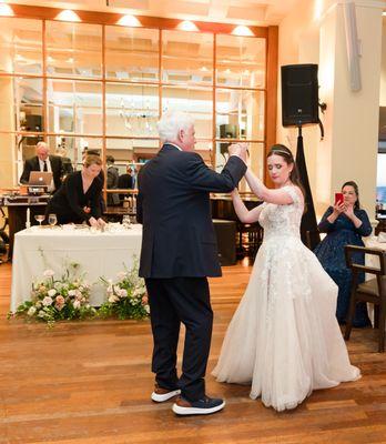 Cierra tidying up our table as I dance with my father