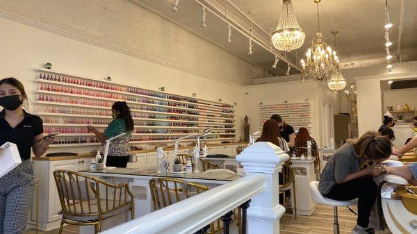 The color wall is to die for. Super organized and manicure space is socially distanced as well.